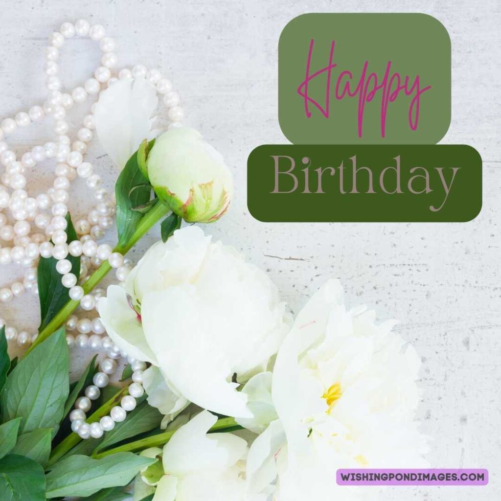 White -colored peony flowers pearls neckless on white-colored wooden table. Happy birthday peonies images