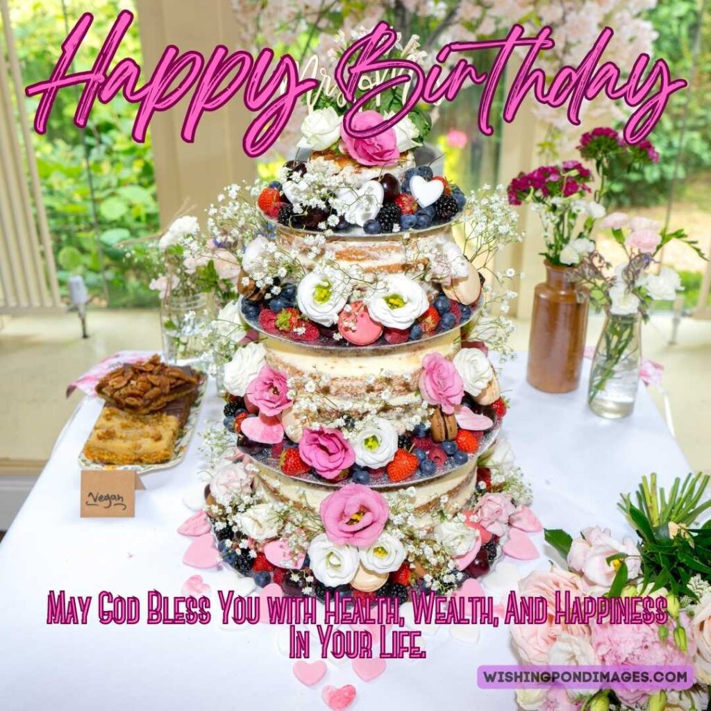 A beautiful four-layered cake with colorful flowers. Happy birthday cake flowers images