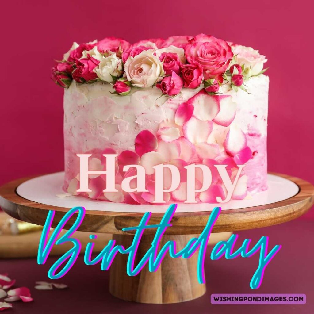 A birthday cake with flowers on top on pink background. Happy birthday cake flowers images