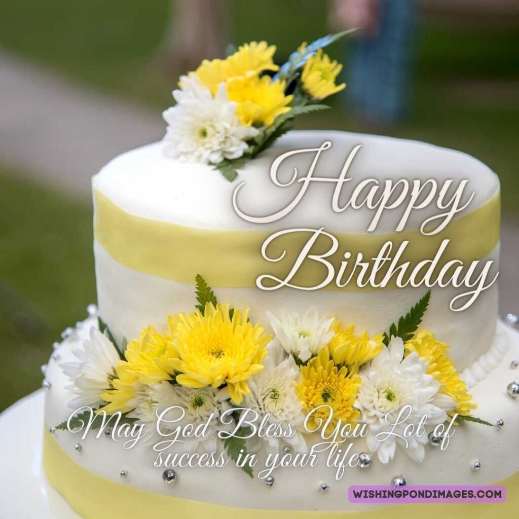 A two-layered beautiful white cake with white-yellow flowers. Happy birthday cake flowers images