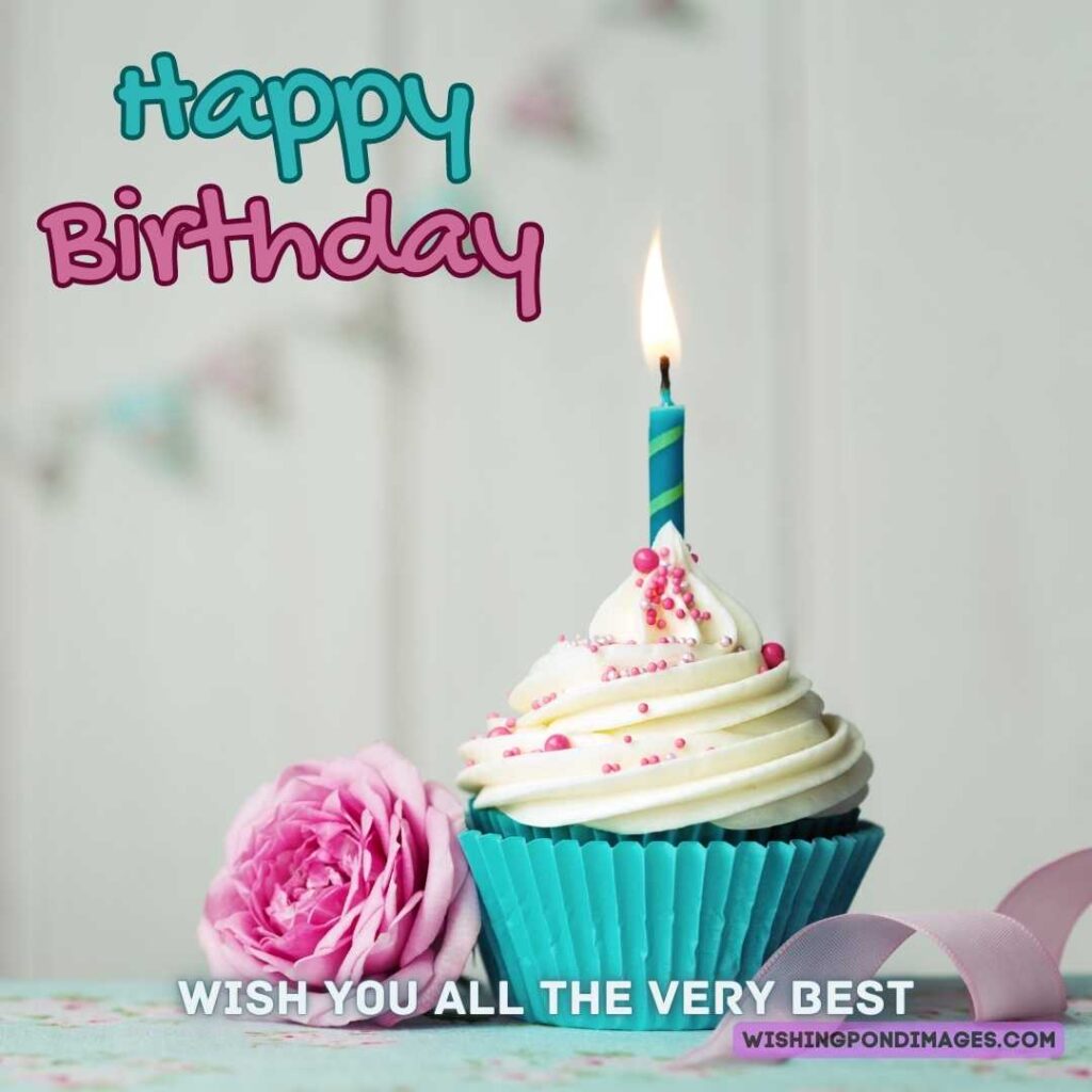 Birthday cupcake with a candle and pink flower on white background. Happy birthday cake flowers images