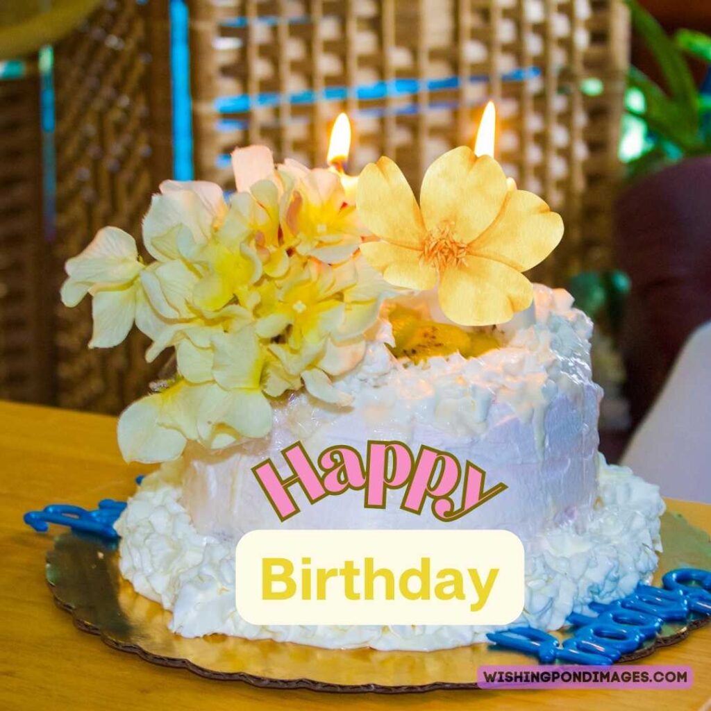 Happy birthday cake with light pink-white flowers on top. Happy birthday cake flowers images