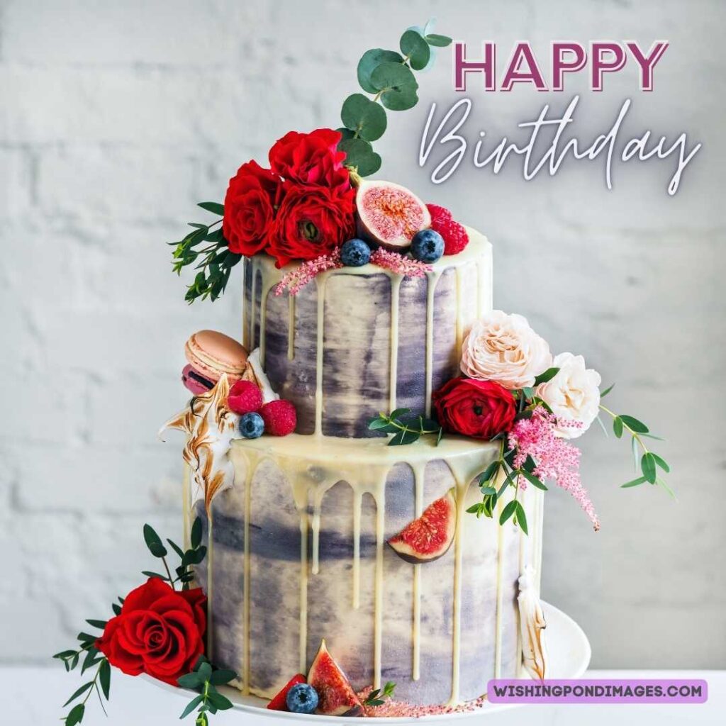 Two layered cakes with flowers and fruits on white background. Happy birthday cake flowers images